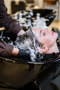 person washing woman s hair